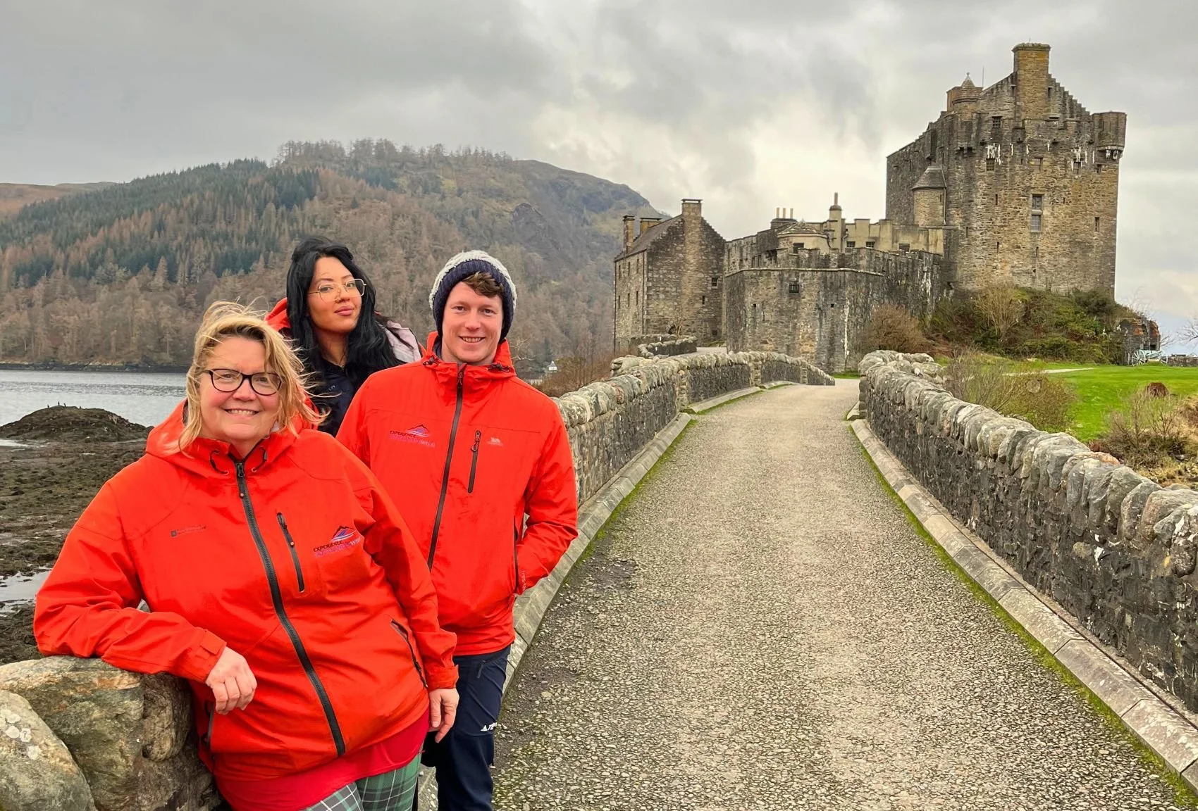 Scotland's Wild travellers together beside a Scottish castle