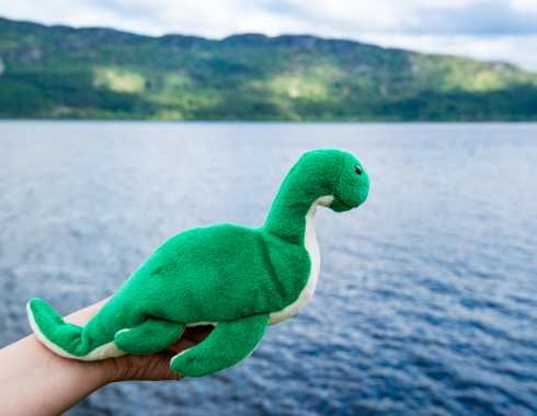 Nessie toy beside Loch Ness