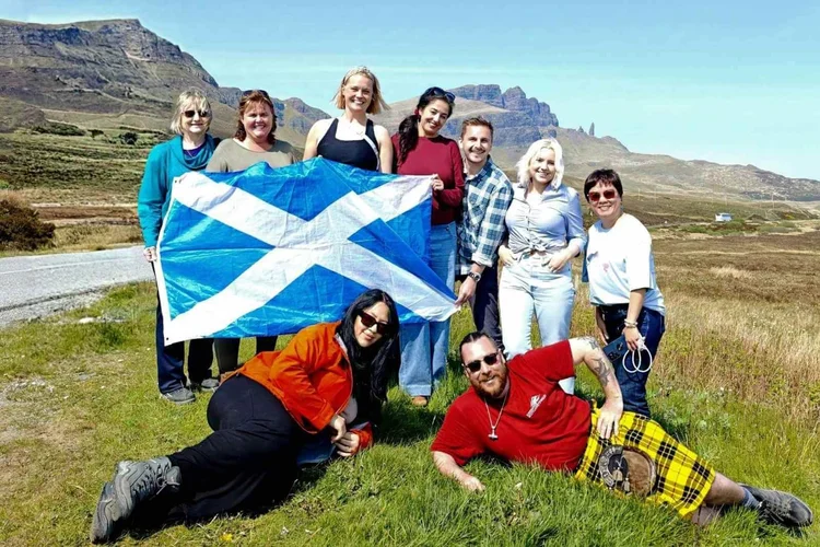 Scotland's Wild guides and a tour group with a Saltire on the Isle of Skye