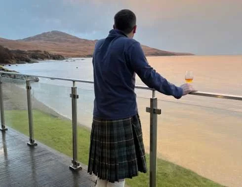 Traveller enjoying a glass of Scotch whisky in Scotland