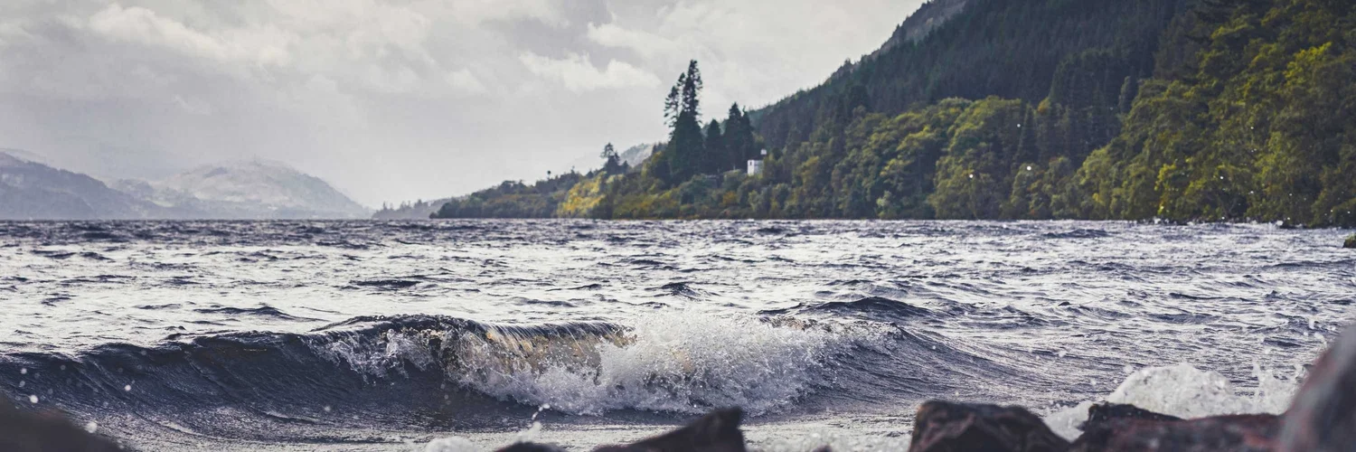 Dark water and steep Highland hills surrounding Loch Ness