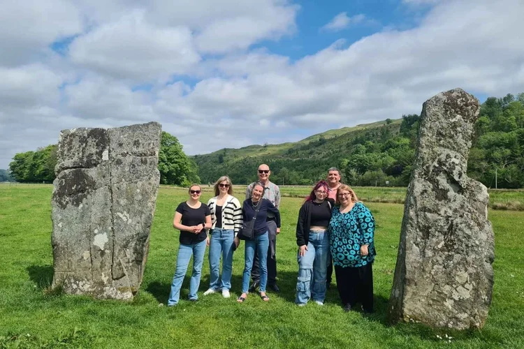 A tour group standing between the standing stones of Kilmartin Glen