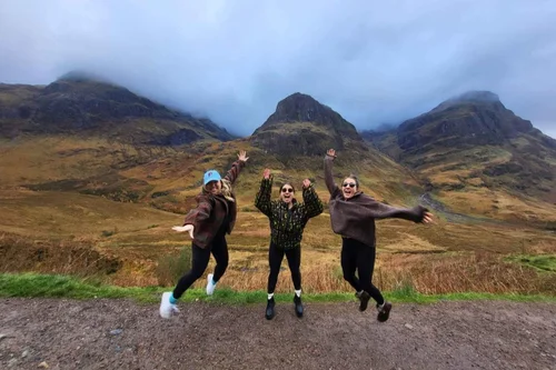 Three guests jumping for joy in Glencoe