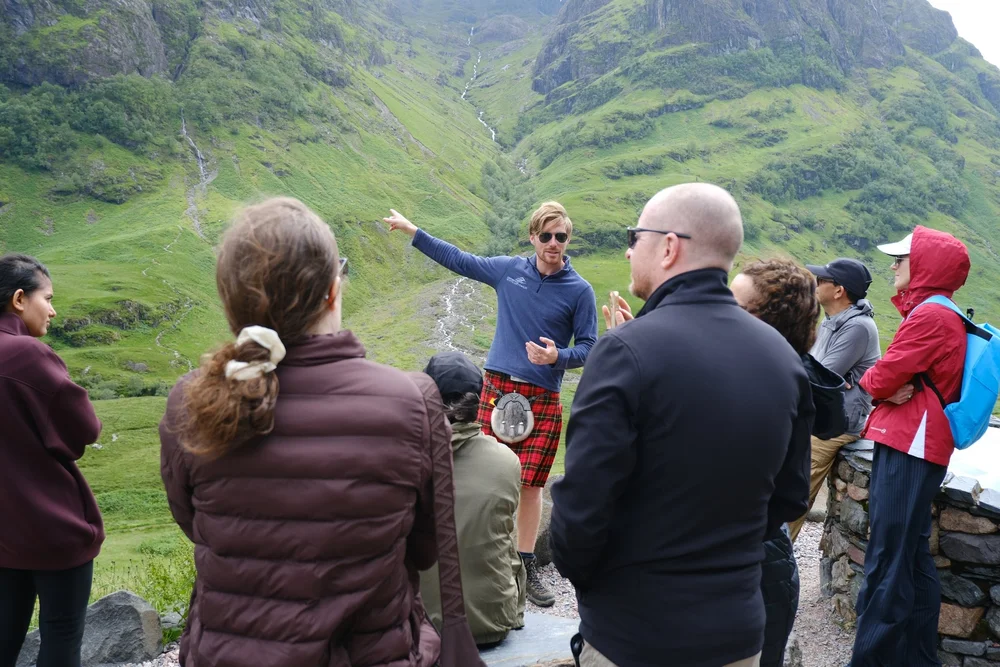 Guide Derek sharing Glencoe's landscape and stories with Scotland's Wild guests en route to Skye