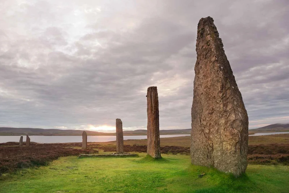 Tall standing stones on Orkney at sunset