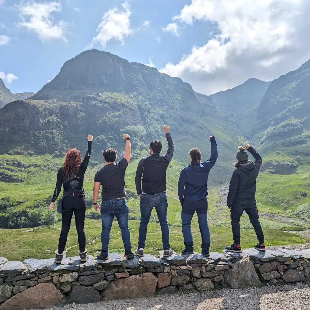 Travellers exploring the dramatic mountains of Glencoe in Scotland