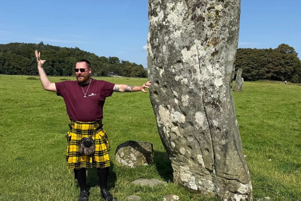 Scotland's Wild guide Matt beside an ancient standing stone