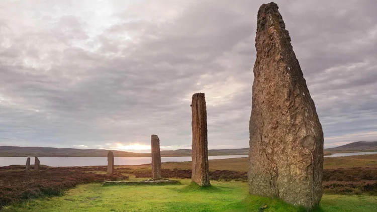 Standing stones on Orkney beneath a wide sky
