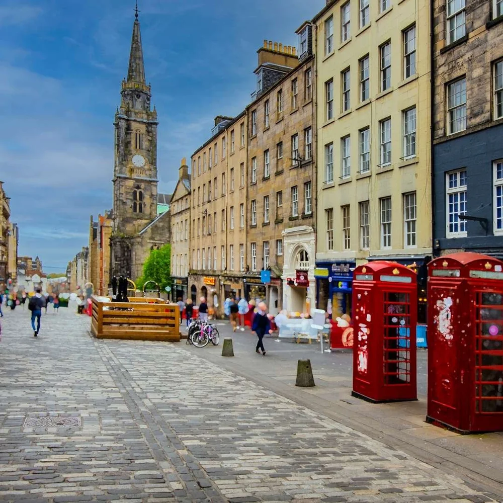 Red phone boxes and tall stone buildings on Edinburgh's Royal Mile