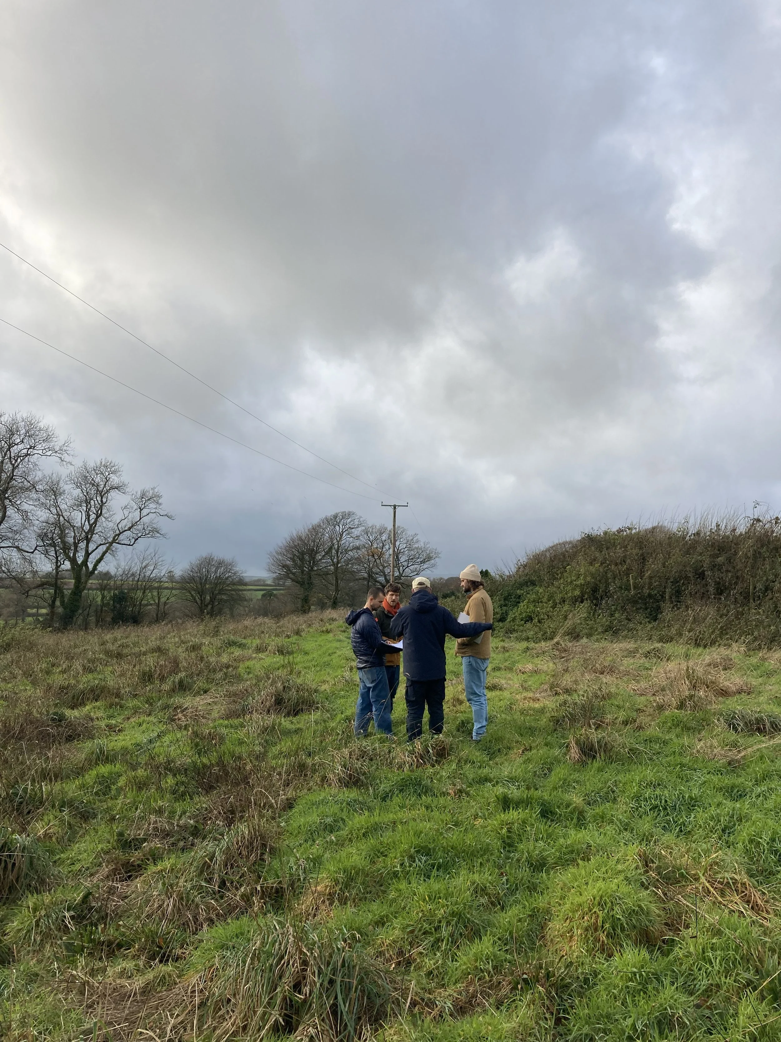 Sam Carew walking mapping the land with his co-design group for the regenerative village project