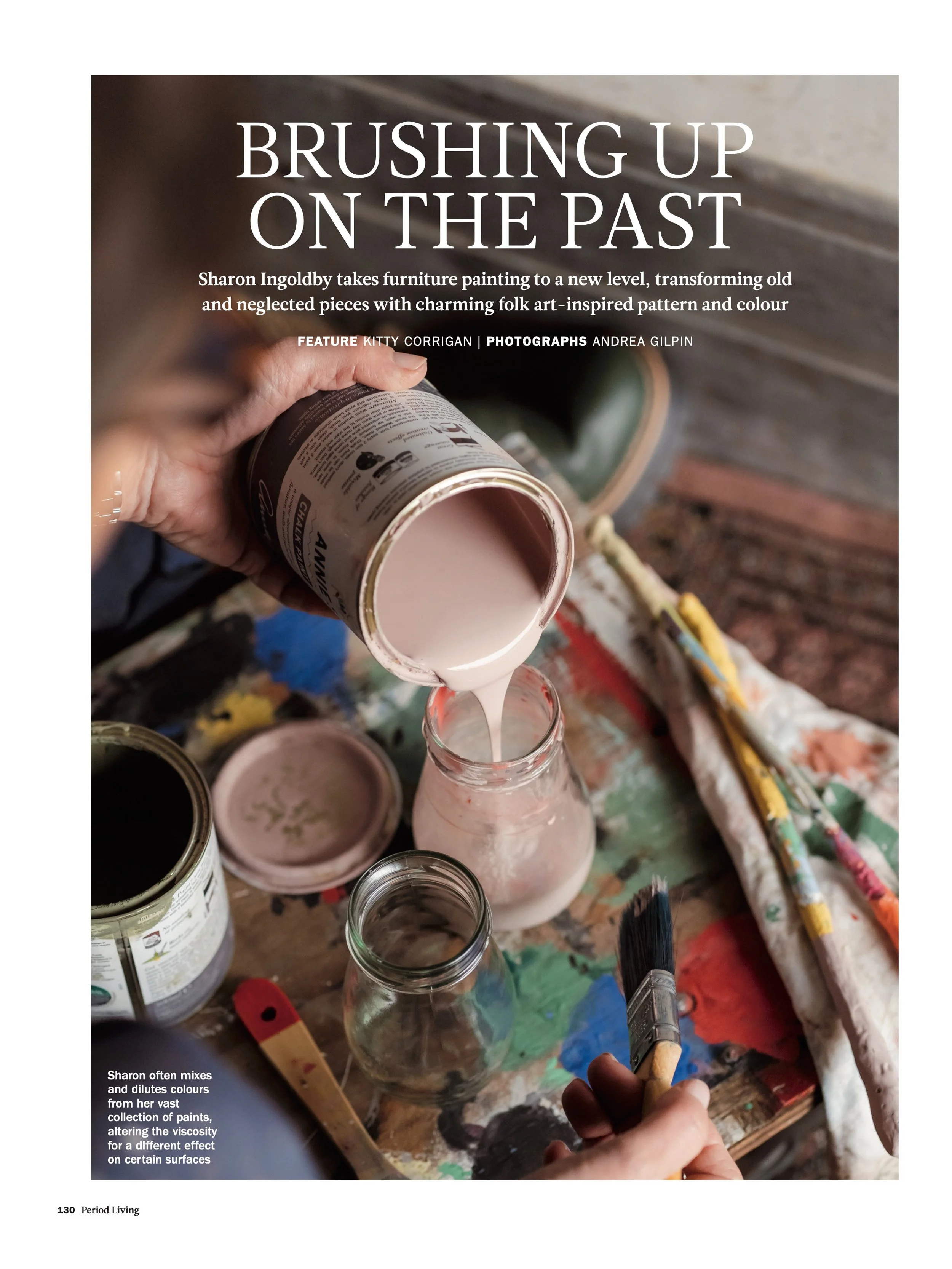 artist in studio pouring paint into jars