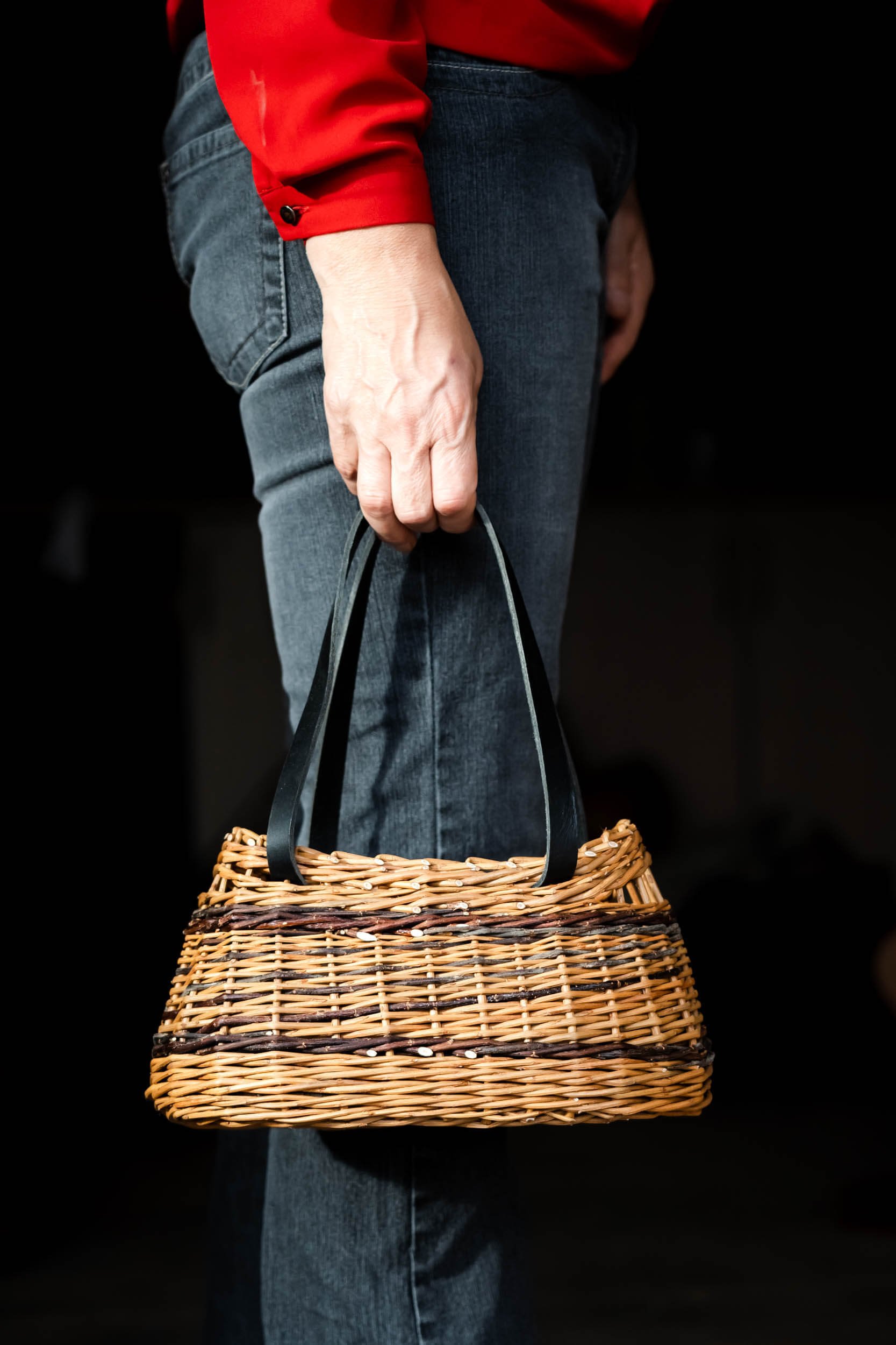 person holding willow bag