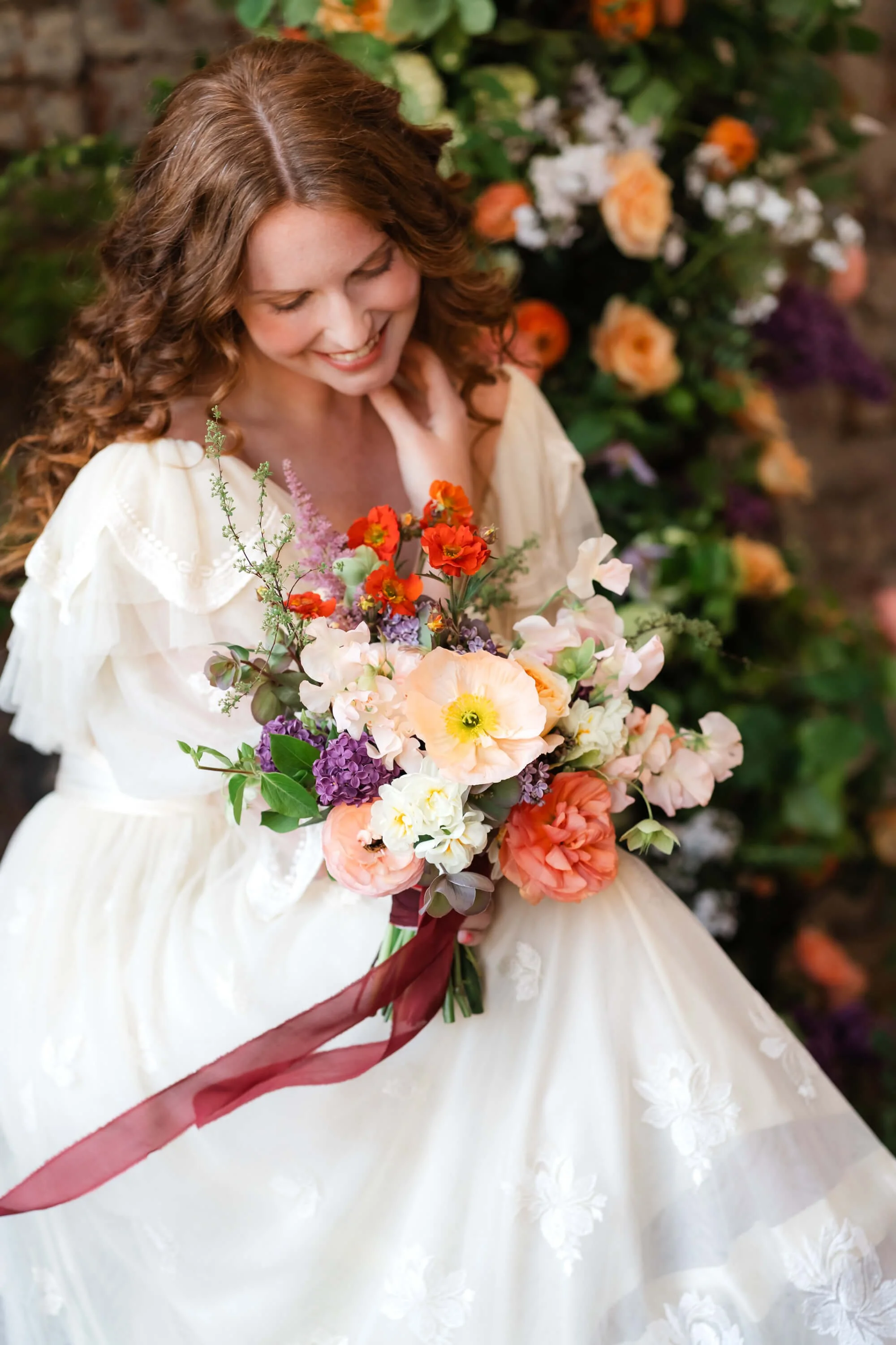 bride-holding-bouquet-at-florists-workshop.jpg