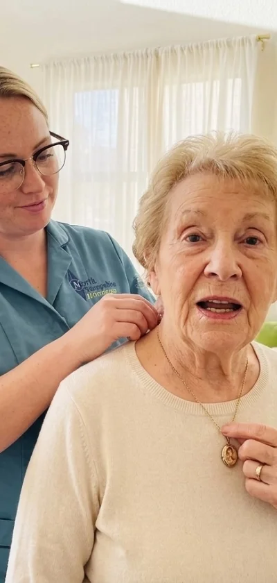 A senior woman receiving a vaccination from a healthcare professional in a room with white curtains.