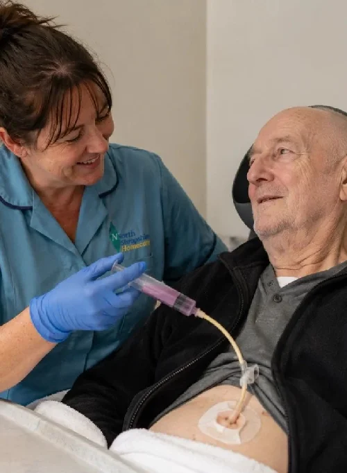 A nurse administers a medical injection to an elderly man in a healthcare setting.