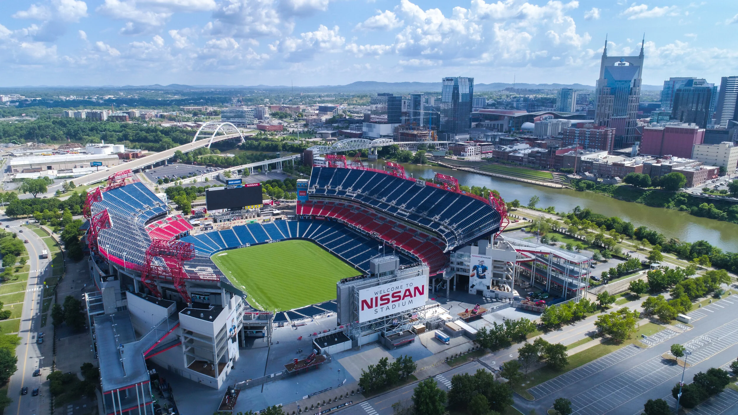 Nissan Stadium in front of Nashville, TN skyline on a sunny day