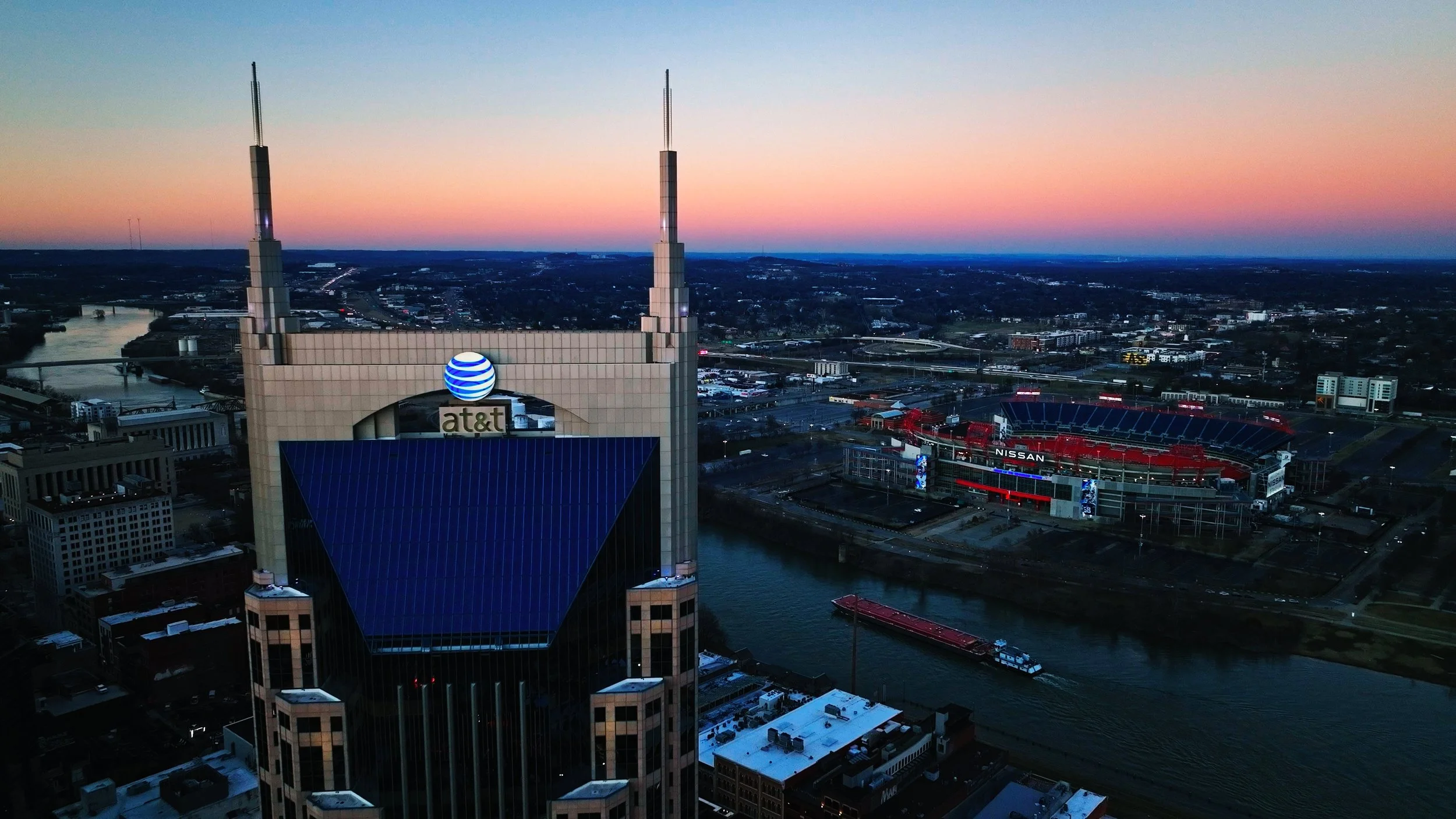ATT Building at sunset in Nashville TN with Nissan Stadium