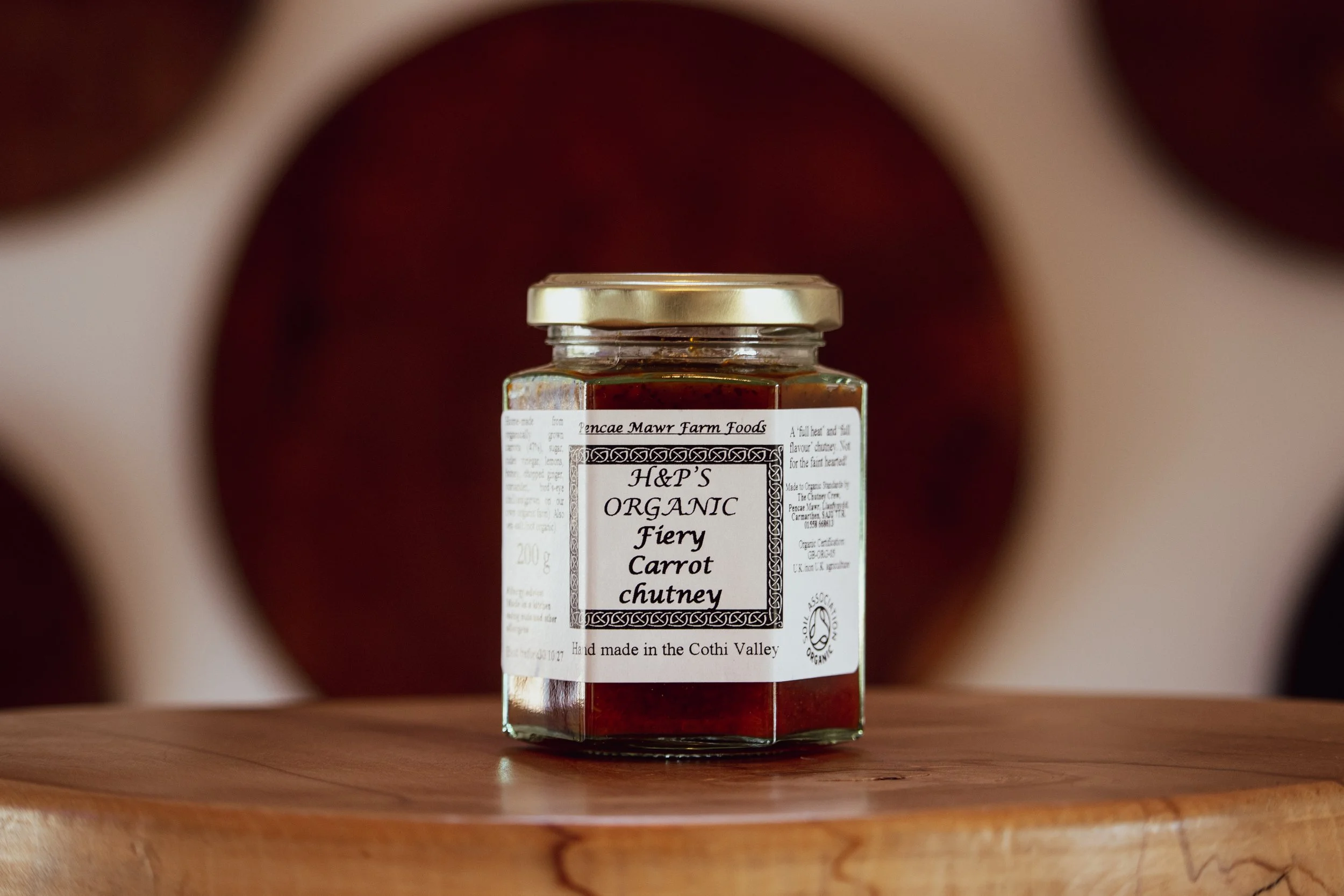 fiery Carrot Relish on wooden table in farm shop