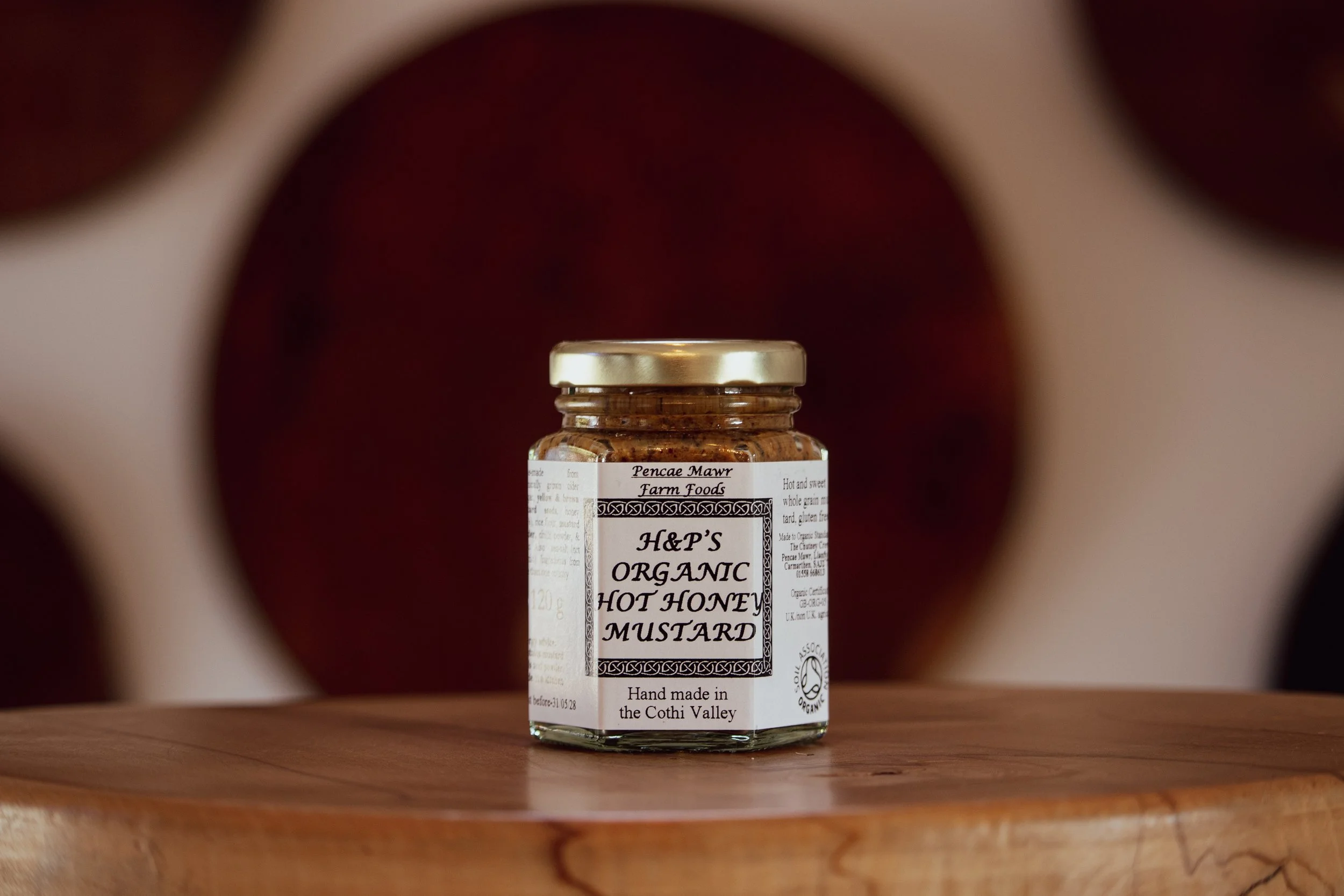 Hot Honey Mustard on wooden table in farm shop