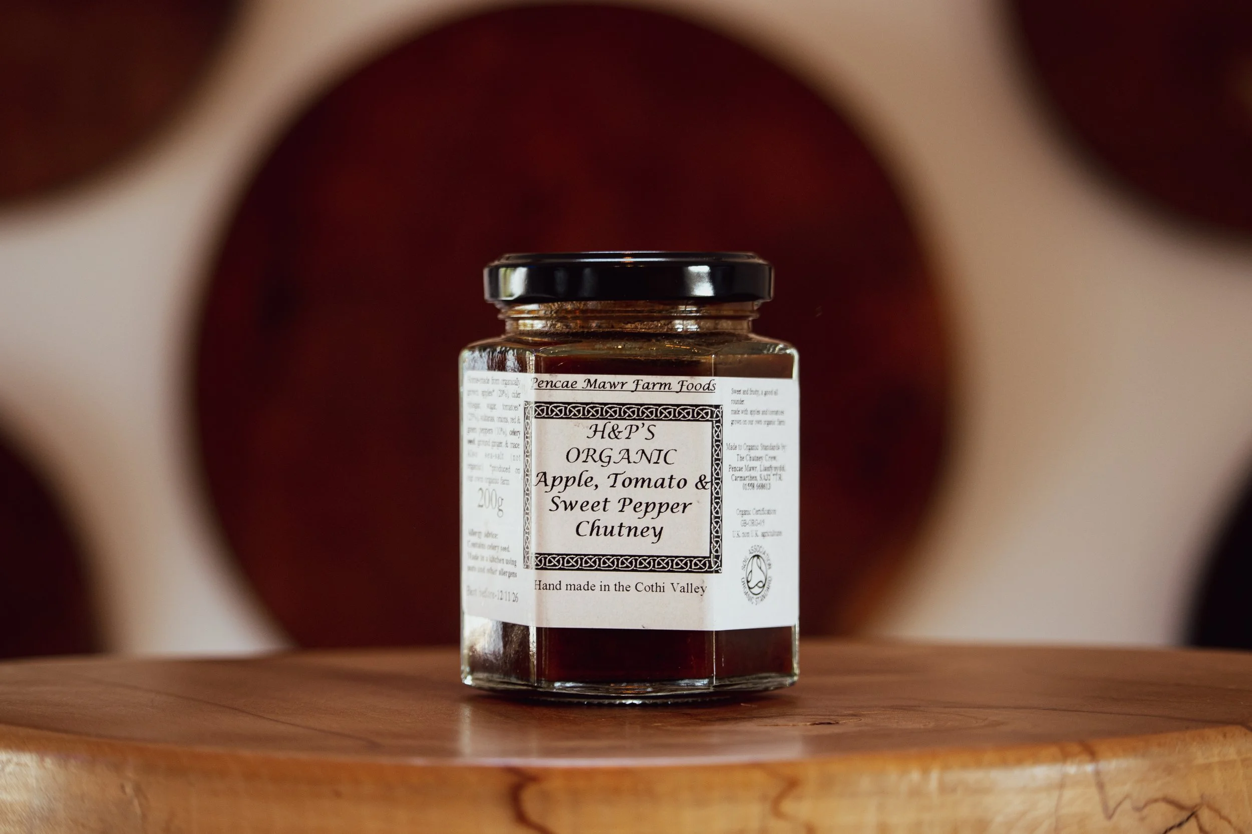 Apple, Tomato & Sweet Pepper Relish on wooden table in farm shop