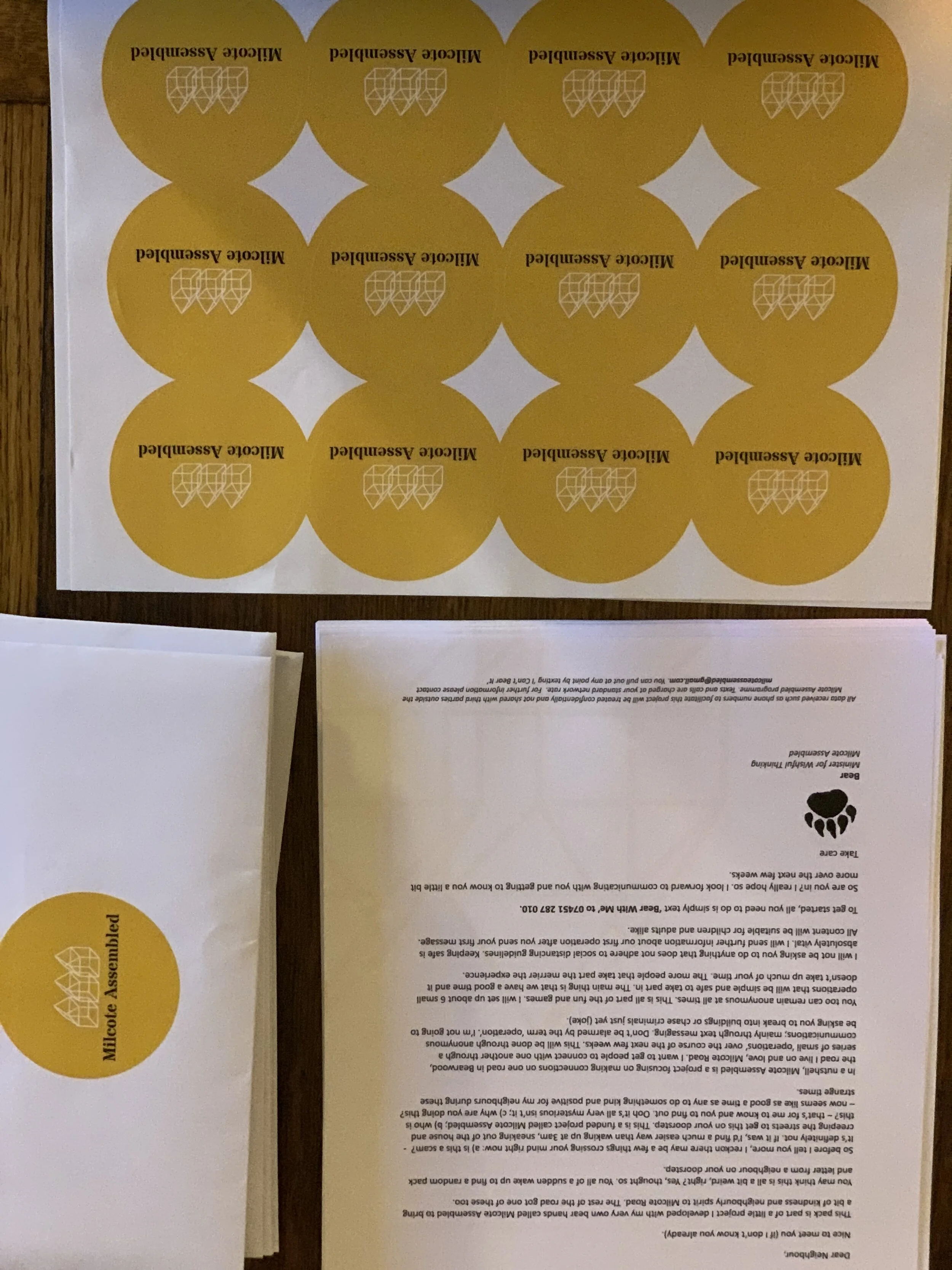 A sheet with yellow circular stickers labeled 'Miltonic Assemble' and some printed text in the background.