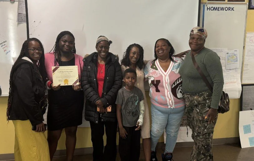 An ARISE student and her family celebrating her Bridge Defense