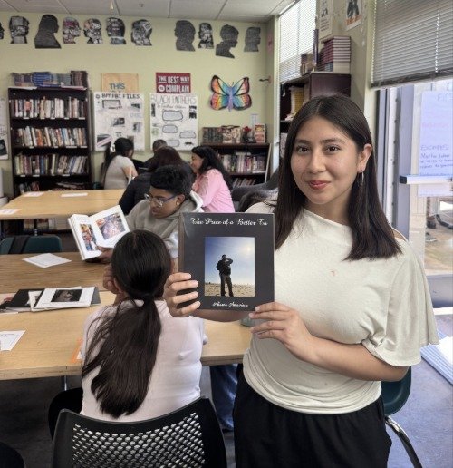 An ARISE Humanities student sharing her Immigrant's Journey photo book