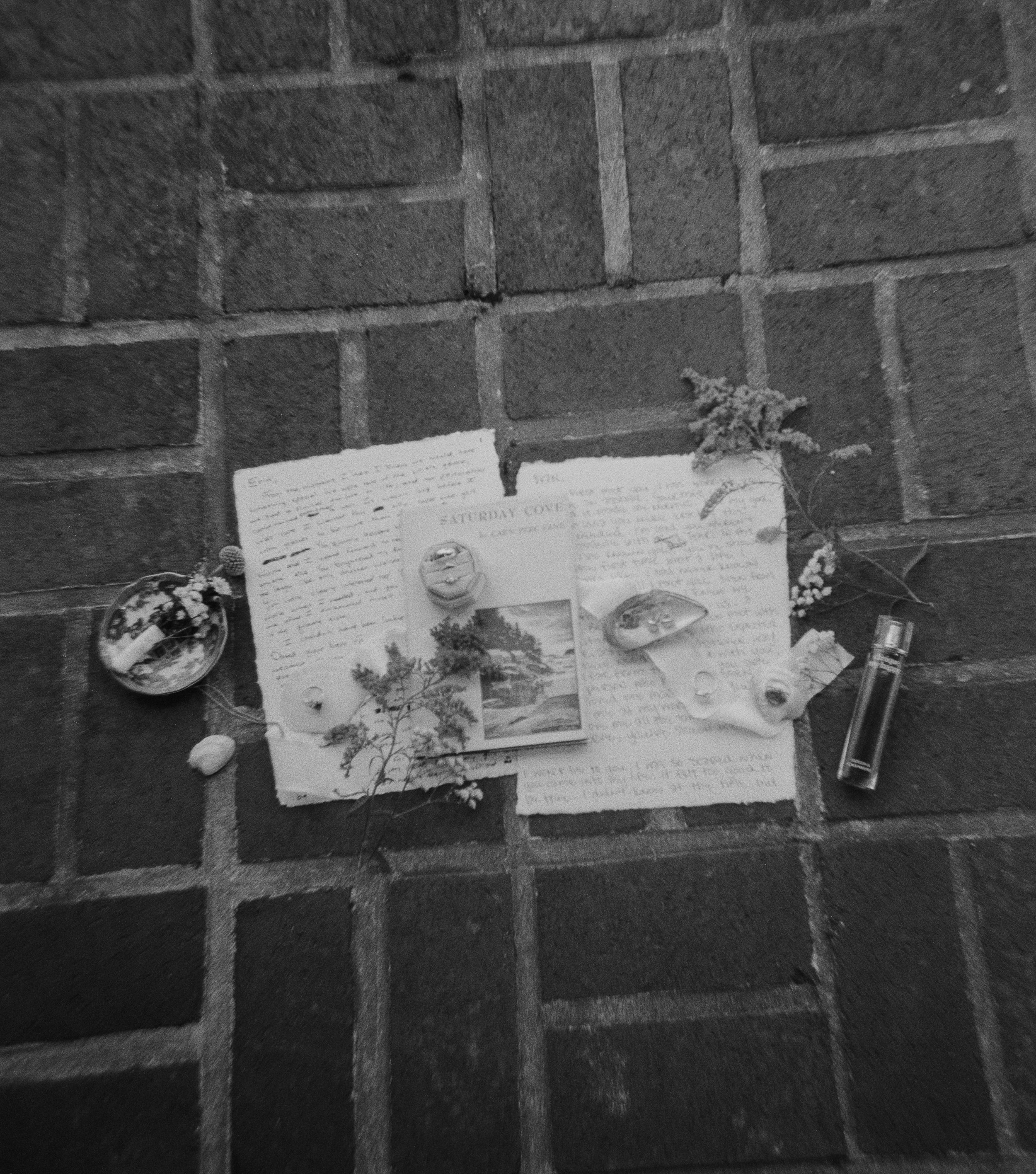 Up close flat lay shot of couples hand written vows and rings