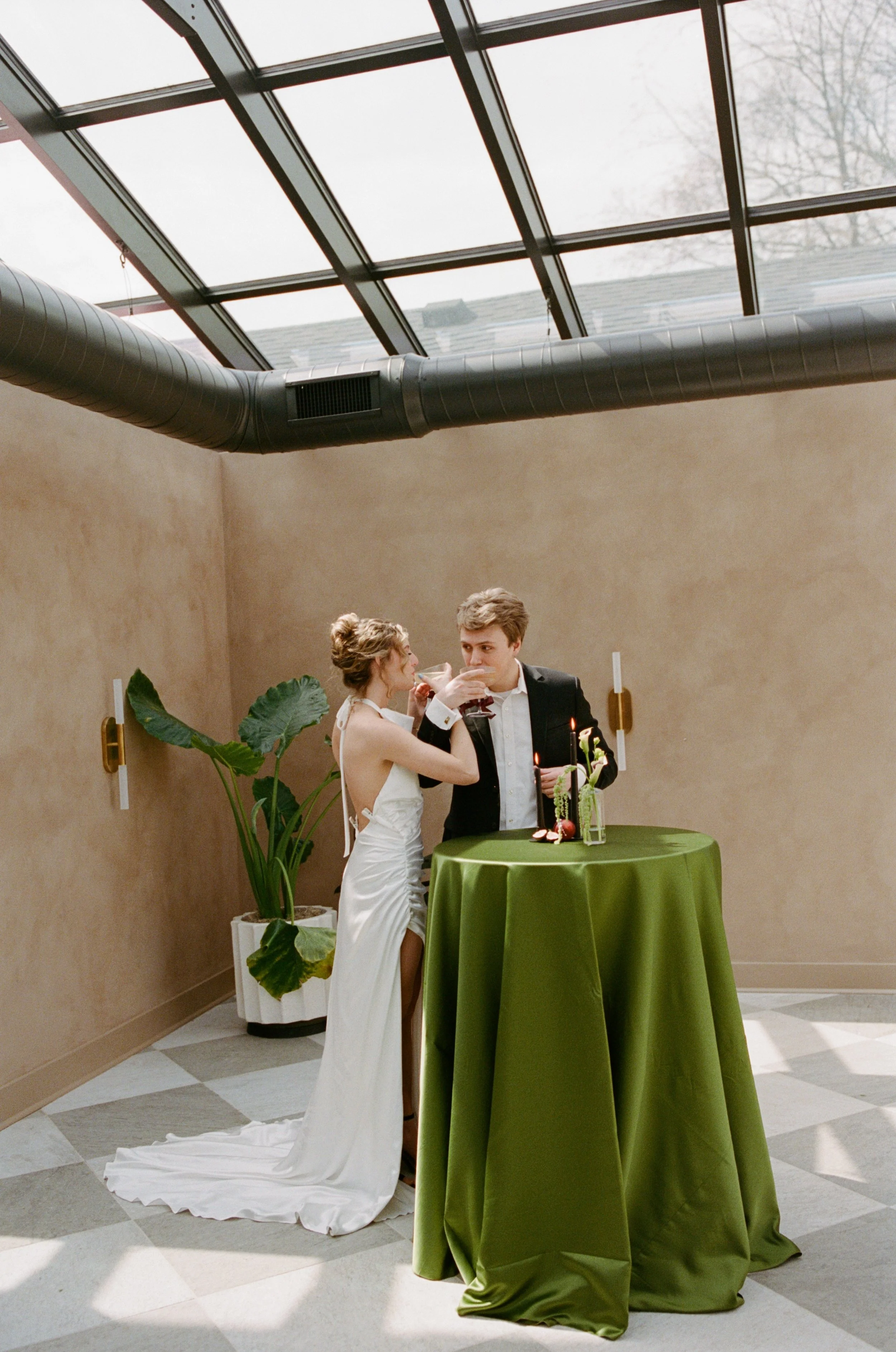 Husband and wife toasting each other on their bid day