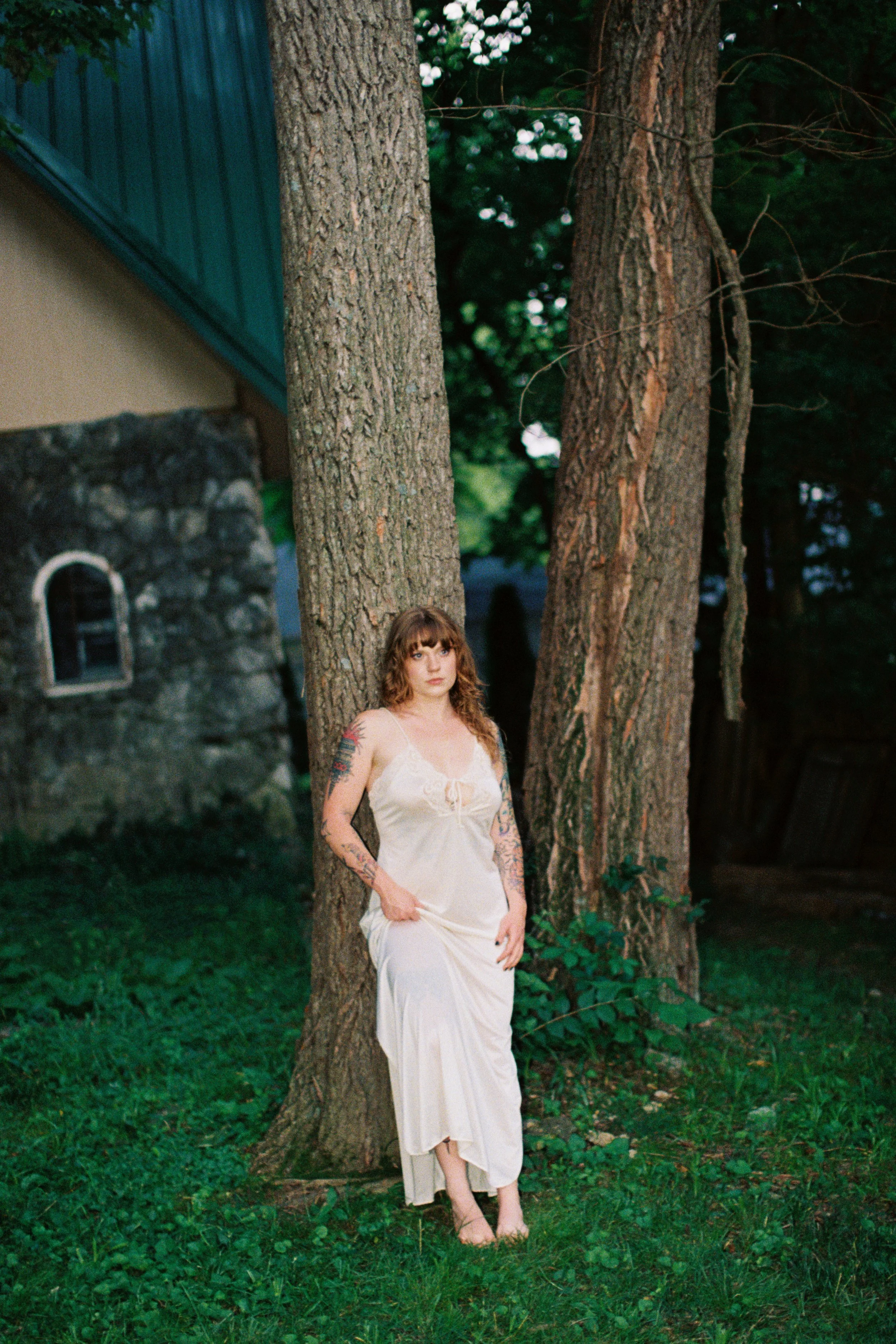 Portrait taken in nature, leaning against a tree