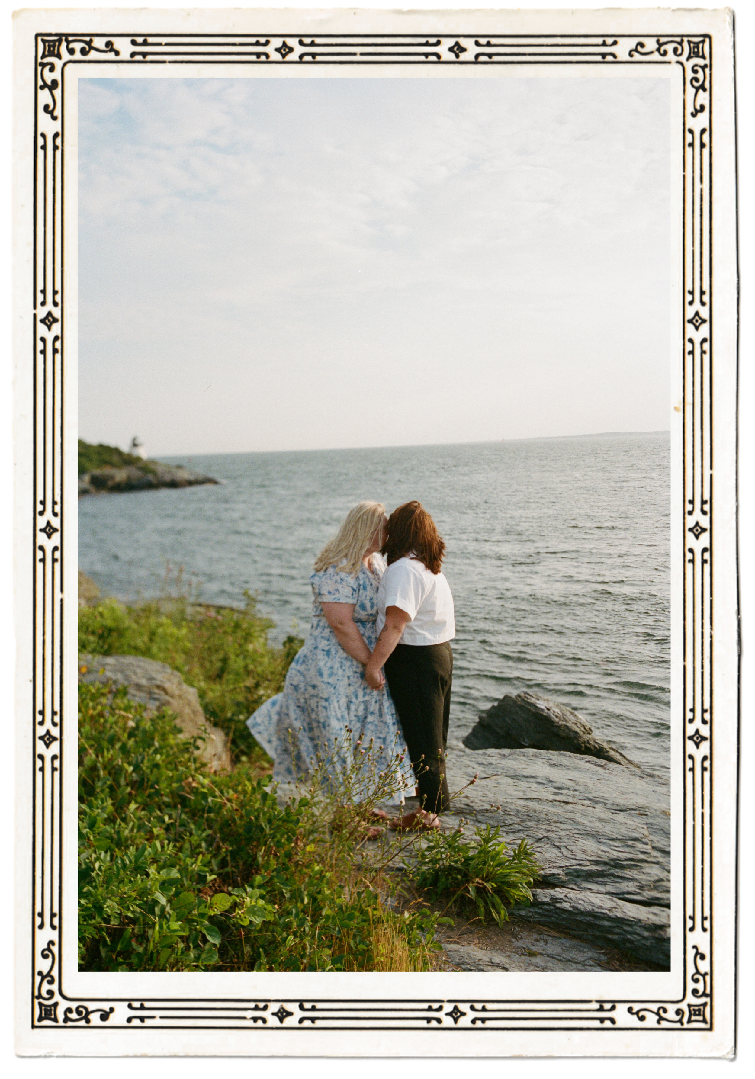 Image of couple on the beach, leaning towards each other holding hands and pressing their foreheads together