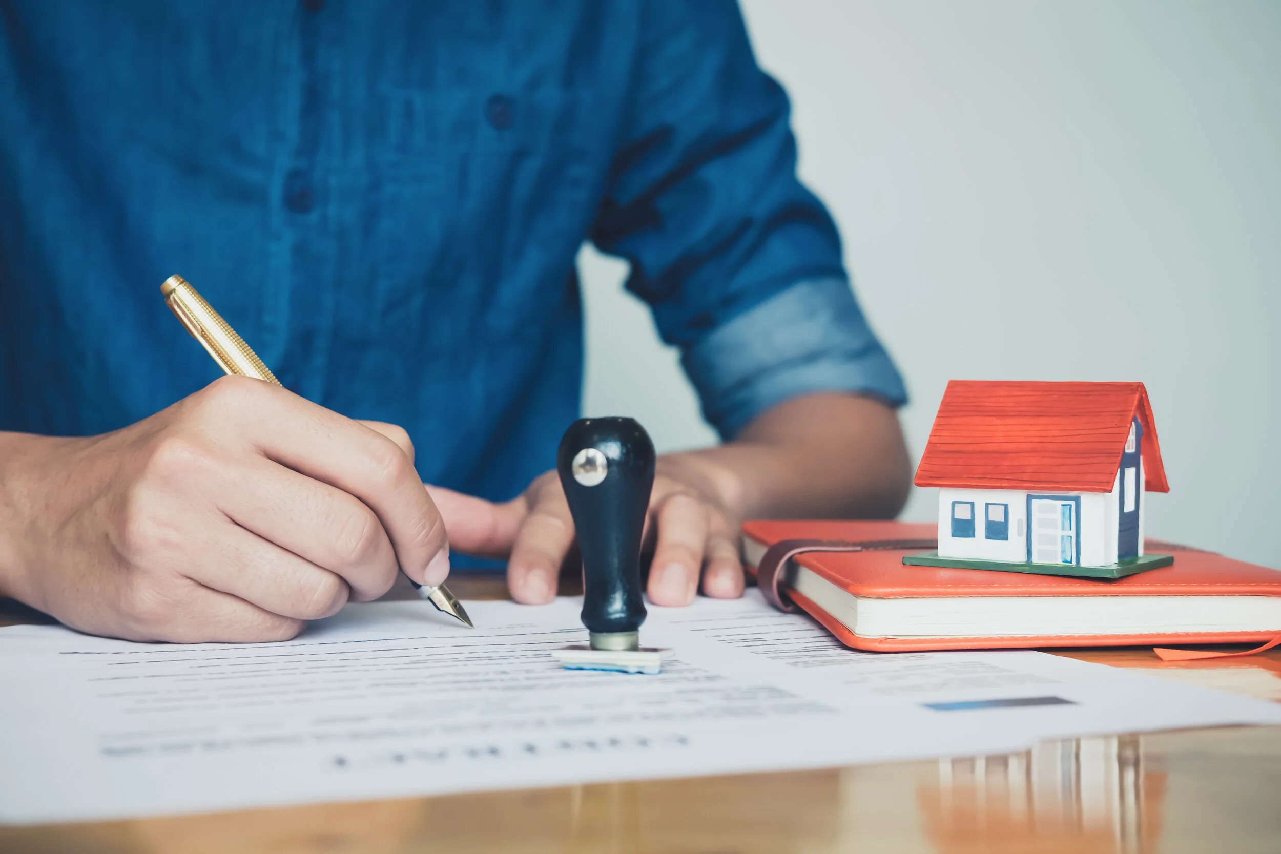 Canva - real estate agent holding house to his client after signing contract,concept for real estate,insurance with house, moving home or renting property.jpg