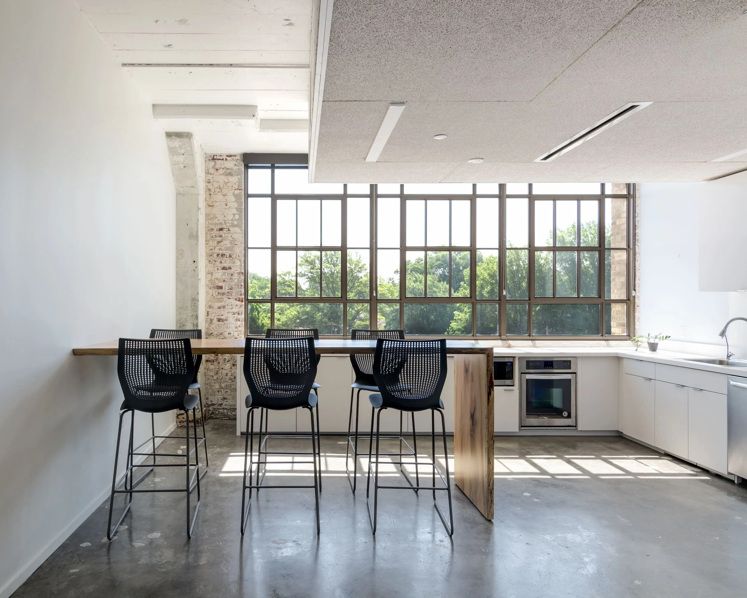 A break room with stools and a live edge table