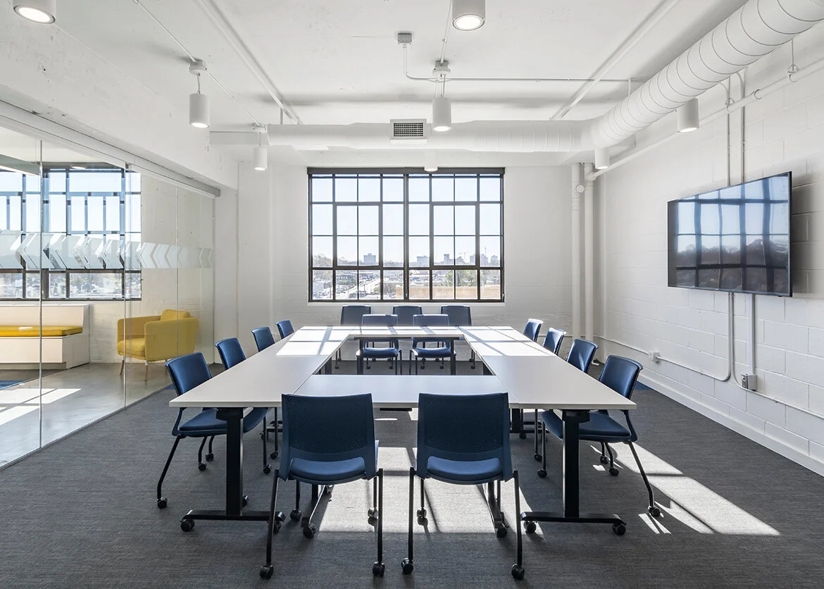 A conference room with a meeting table and task chairs