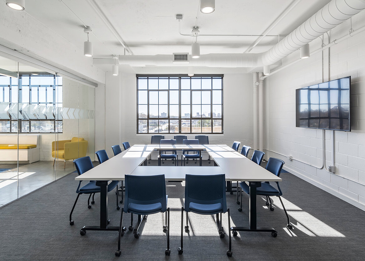 A conference room with a meeting table and task chairs 