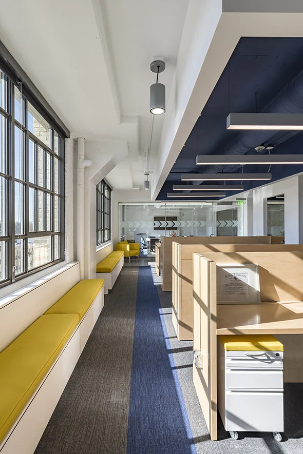 Workstations, mobile storage, and bench seating in an office