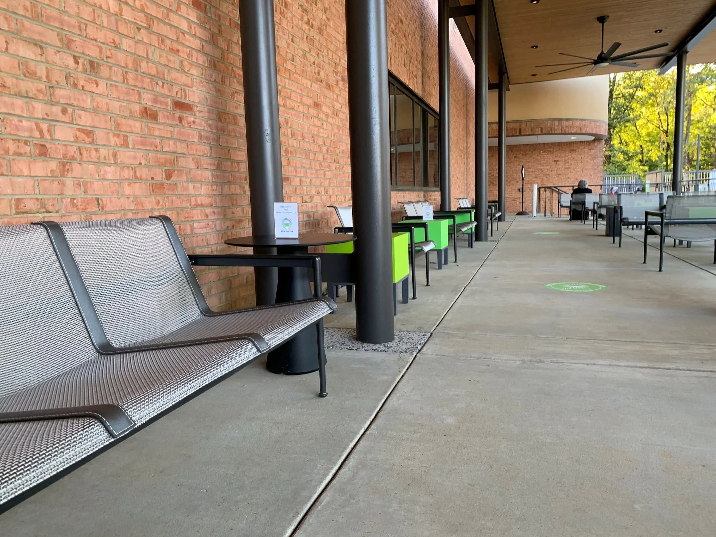 Reconfigurable outdoor furniture at an entertainment venue includes chairs, benches, and side tables 