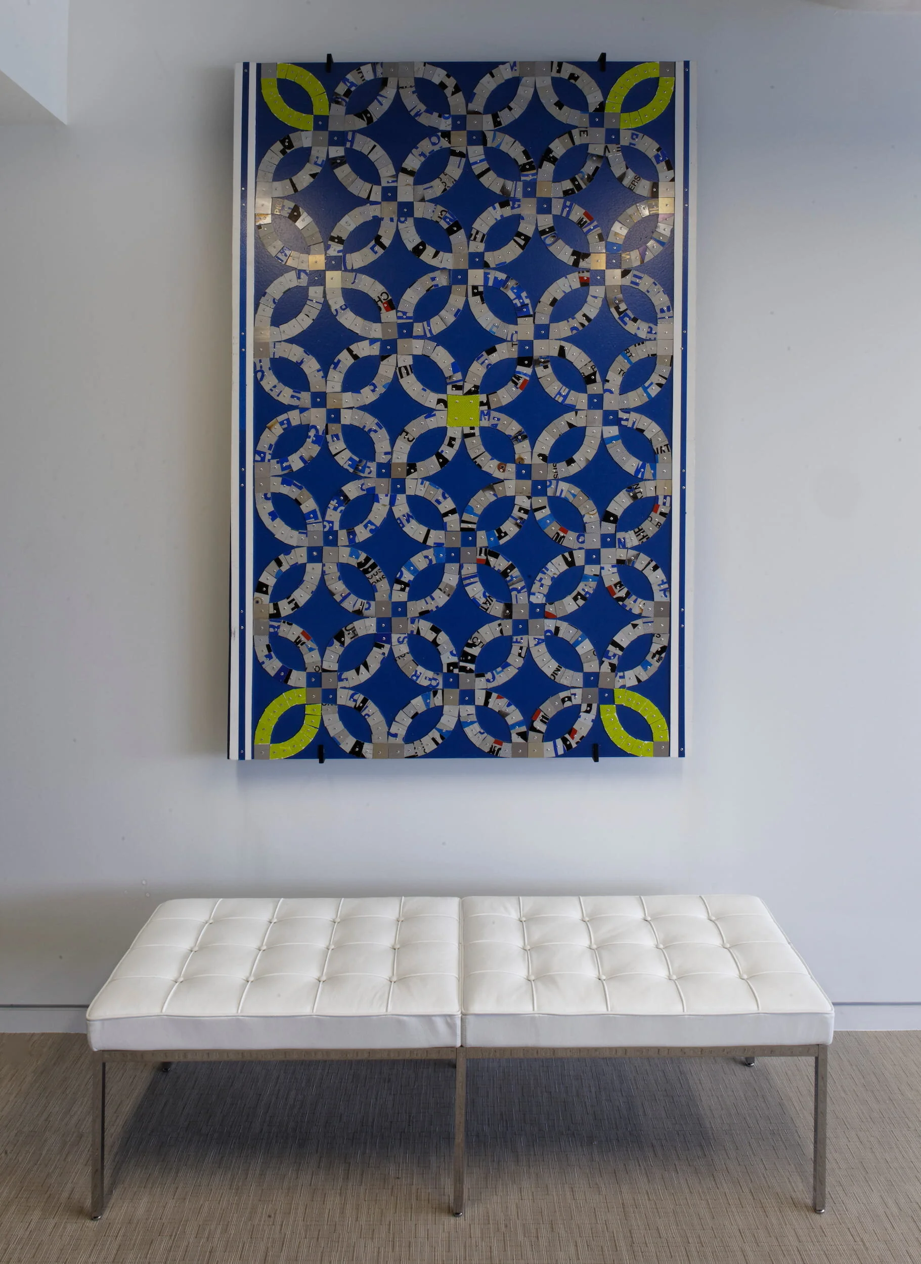 A Florence Knoll bench sits below wall art at Mercer Capital