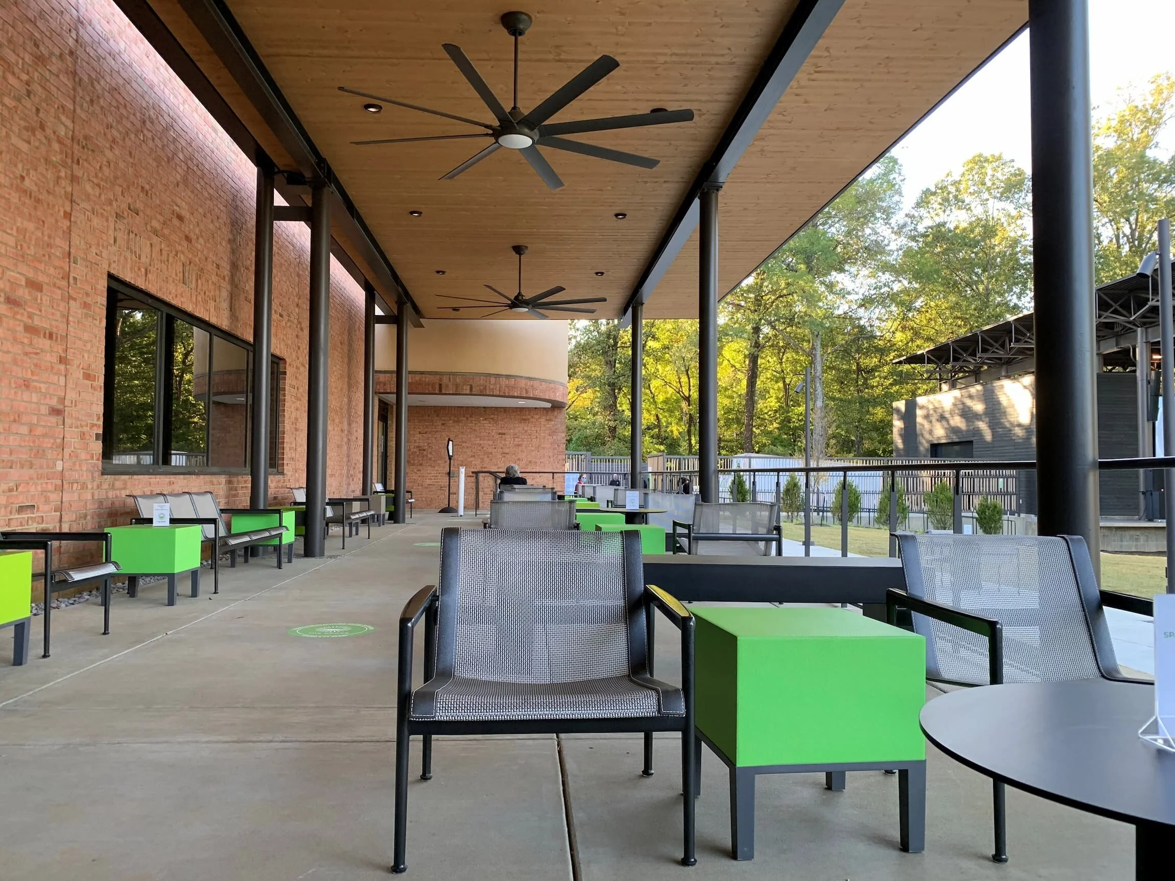 An outdoor entertainment venue with reconfigurable chairs, benches, and side tables 
