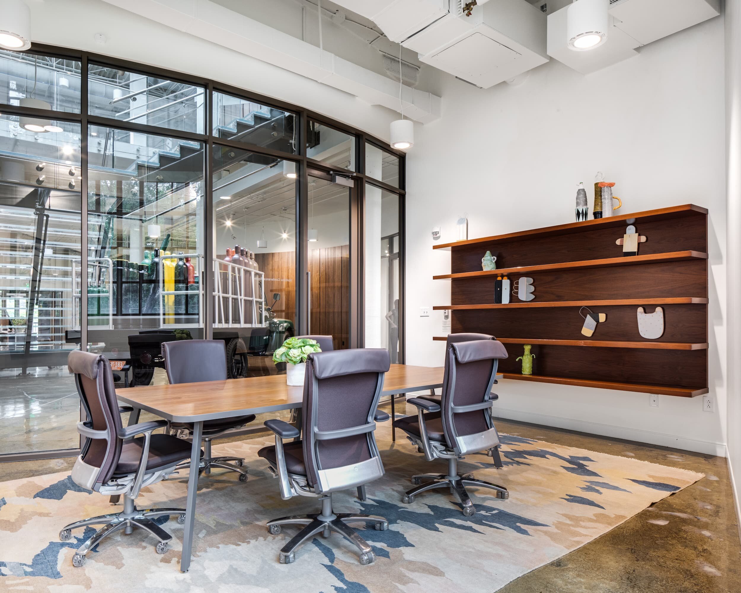 A meeting room in the nexAir office with a conference table and task chairs