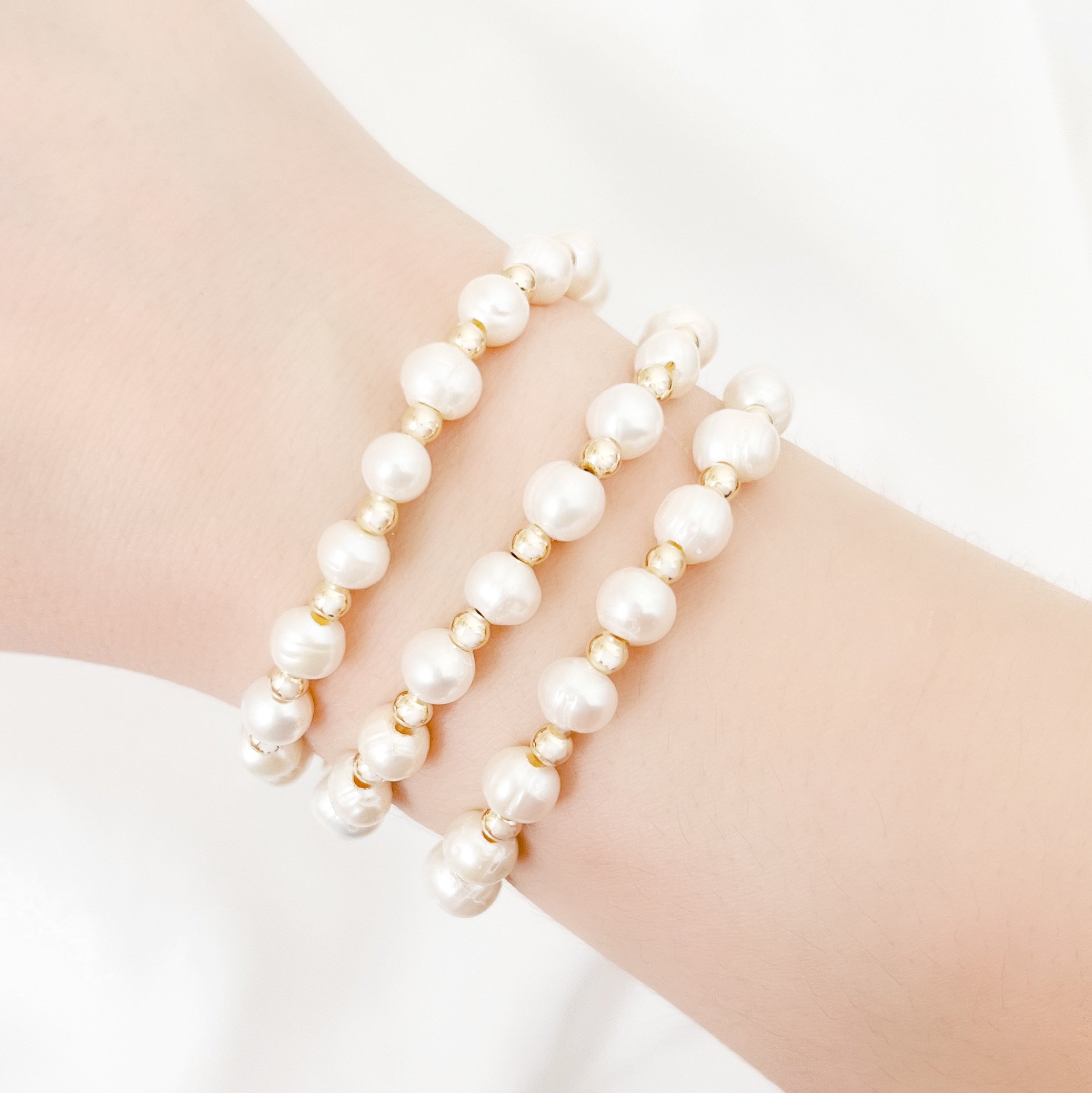 golden pearl bracelets on.JPG
