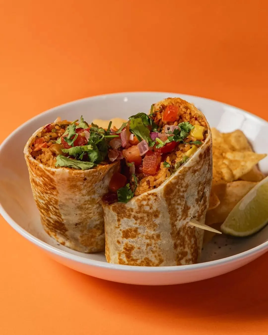 The Lil Burrito Wrap is packed with your choice of protein, dirty rice, pit beans, jalape&ntilde;o, salsa roja, Oaxaca cheese, guacamole, pico de gallo and a squeeze of lime. Every wrap is made fresh with hand selected ingredients for real flavour in