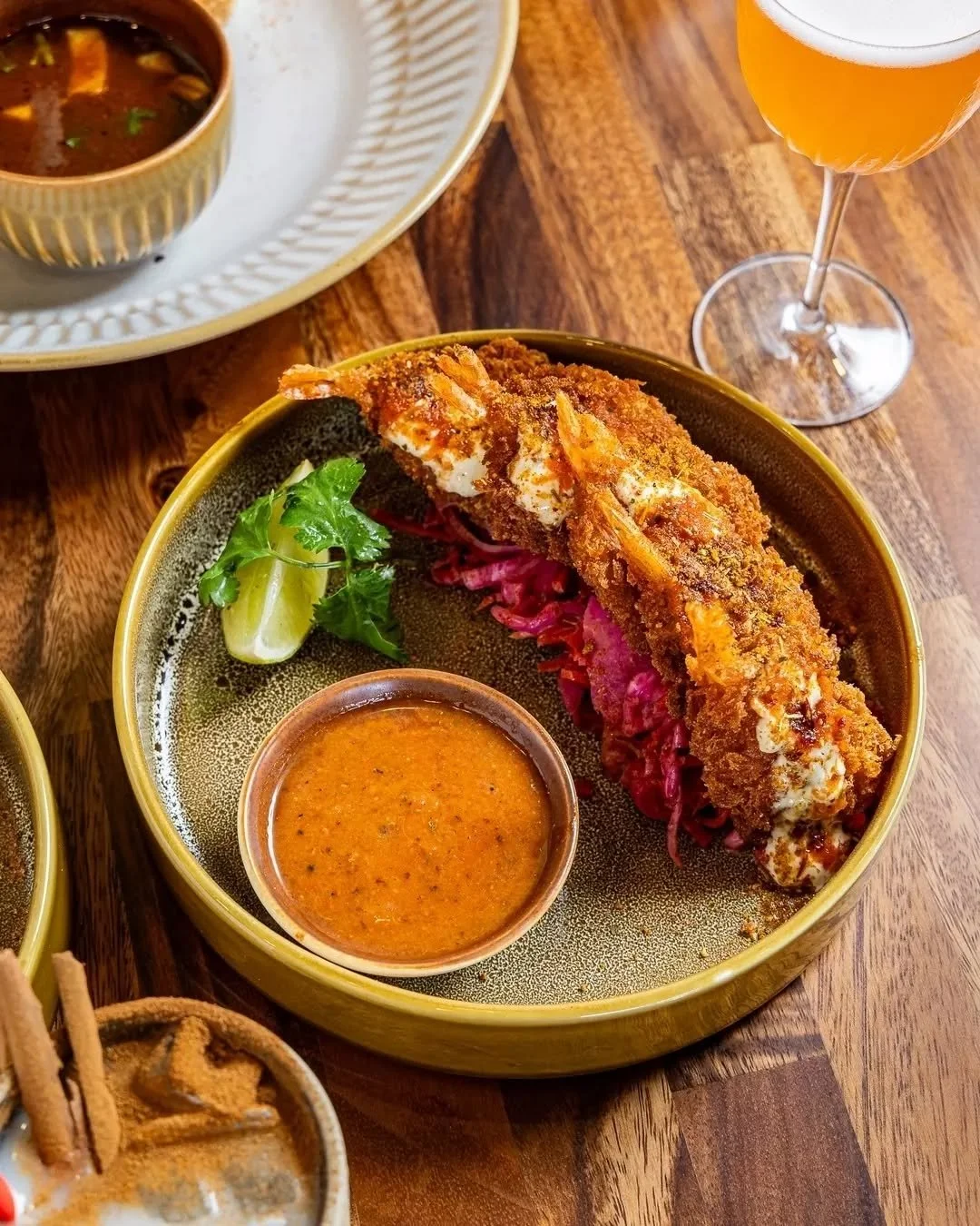 Camarones Dorados brings together crunch and clarity. Jalape&ntilde;o buttermilk softens the heat, paprika adds warmth, and lime cuts through to finish.