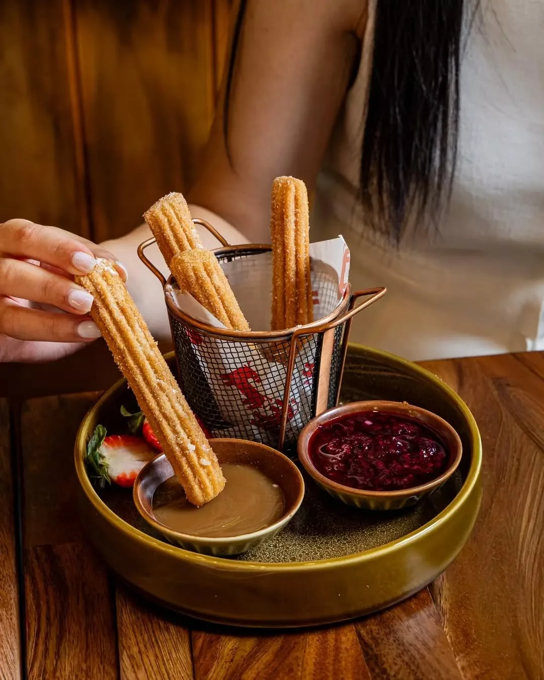 A classic Mexican finish. Golden churros rolled in cinnamon sugar, served with dulce de leche and mixed berry compote.