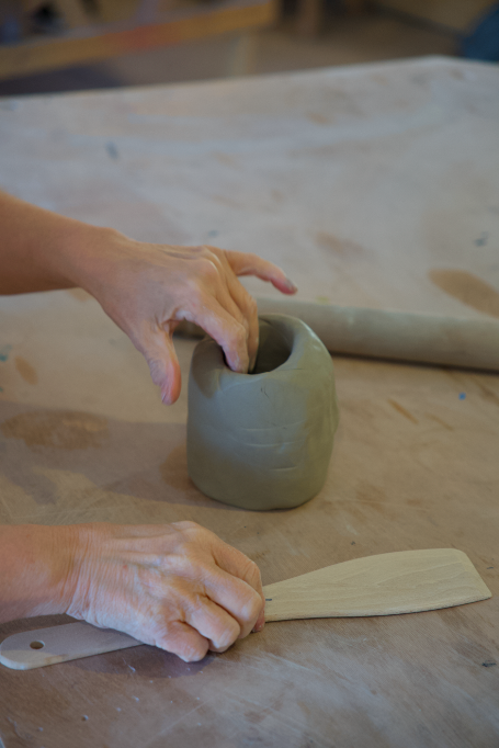 A spoon, a spatula and a rolling pin.