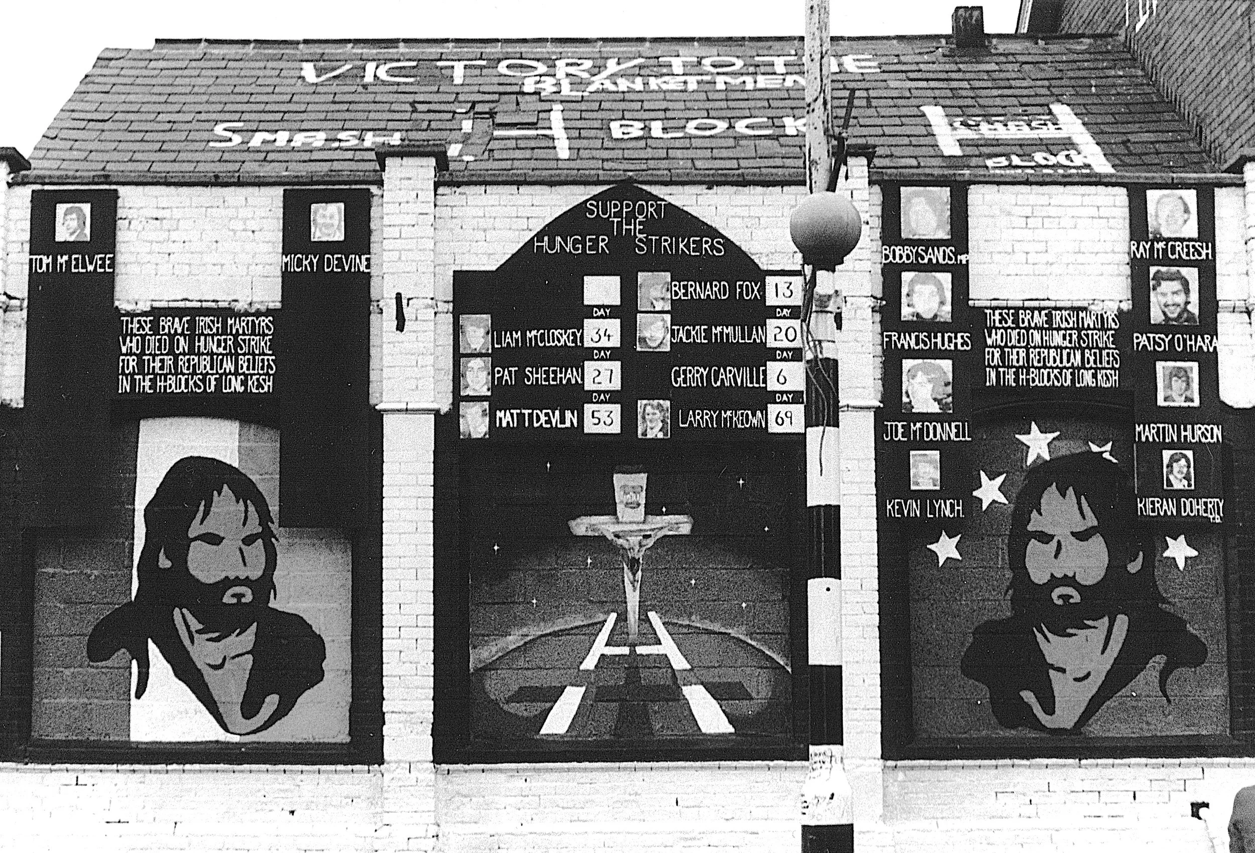 Graffiti mural commemorating Irish hunger strikers, featuring portraits and text honoring those who died for their beliefs. The mural includes imagery and statements about the strike and Long Kesh, with references to "Victory to the Blanketmen."