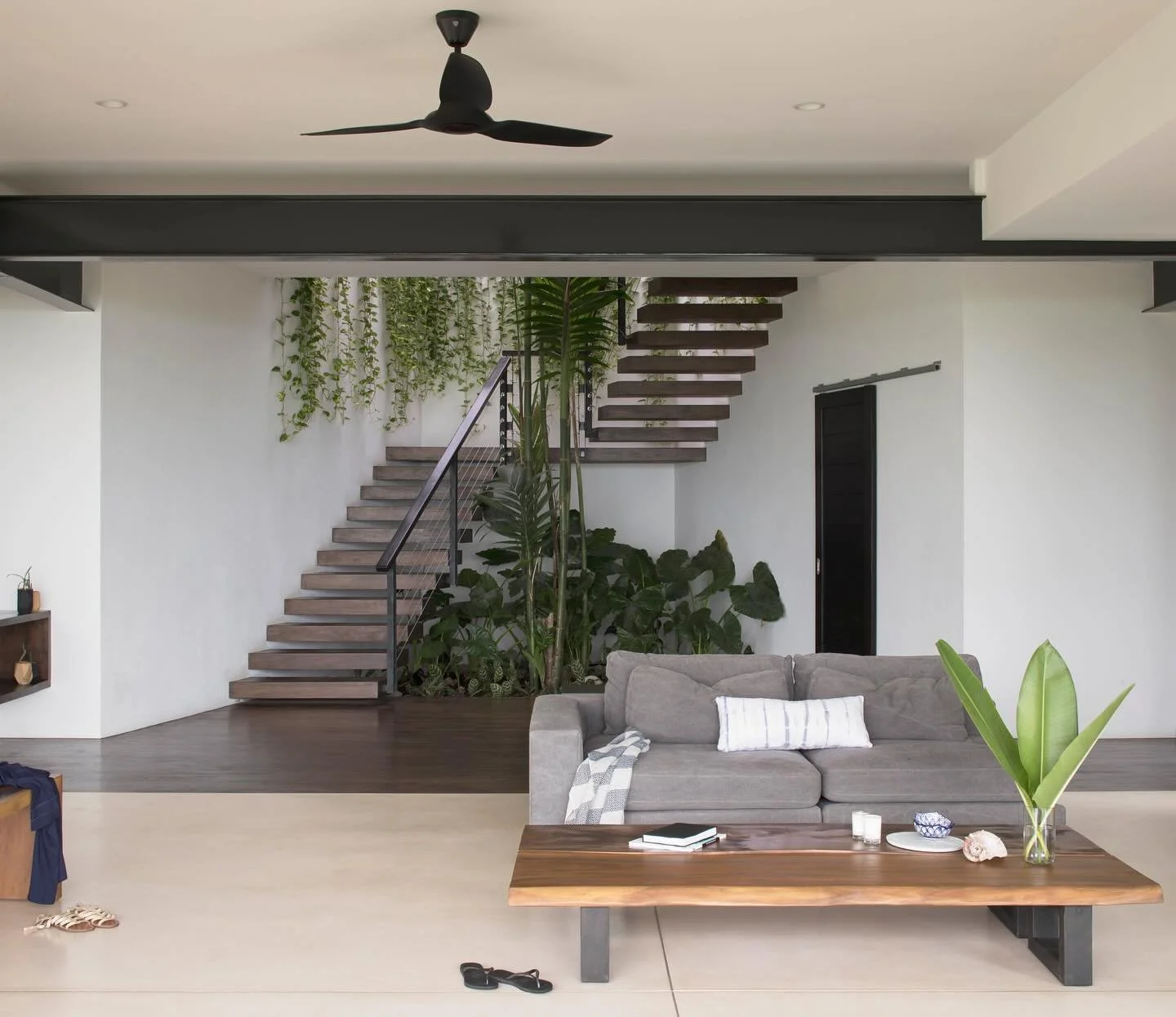 🌴✨ Tropical modern living! This stunning open-plan space a blend of minimalism and elegance. Featuring an exposed staircase and sleek design, it brings the beauty of simplicity into your home. airy, light-filled sanctuary, where every detail is craf