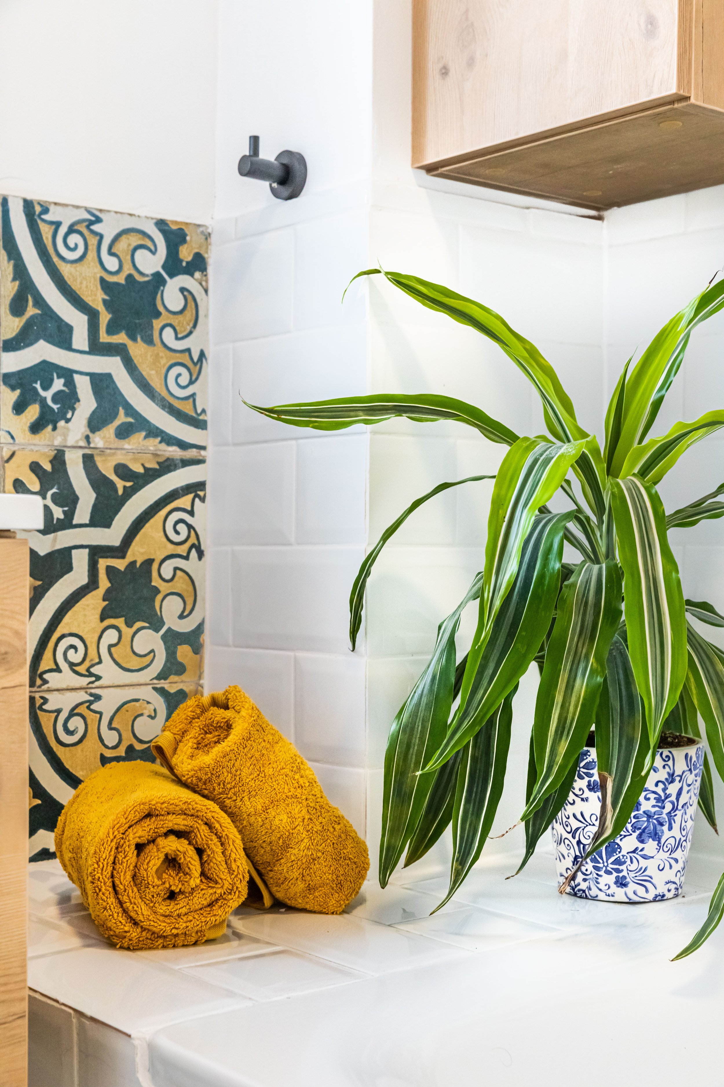 Mustard yellow bathroom towels and green plant.jpg