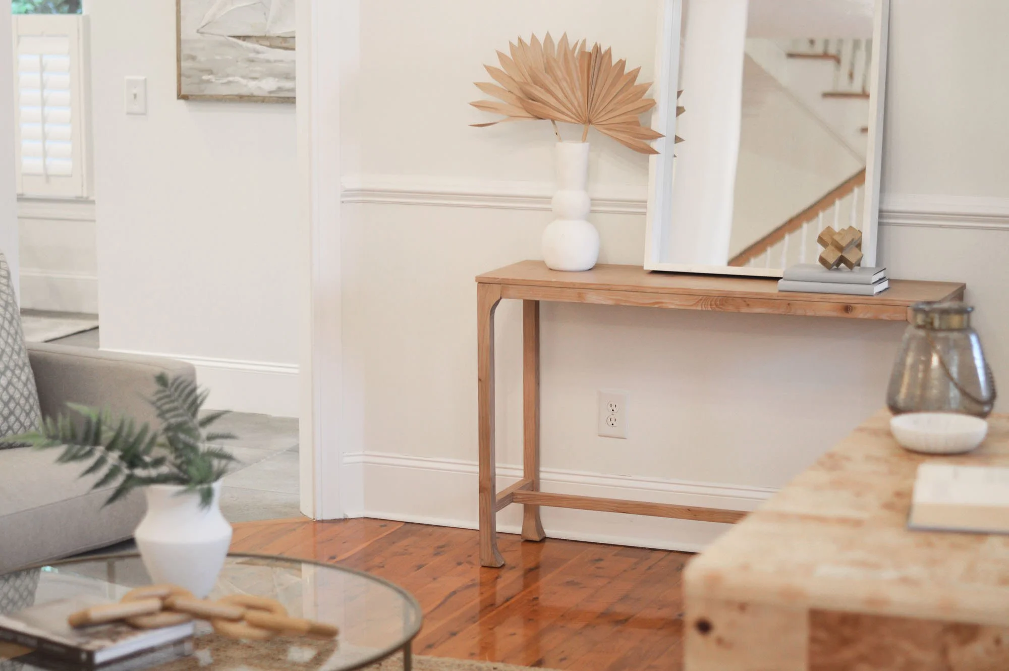 den with console table, mirror and plant