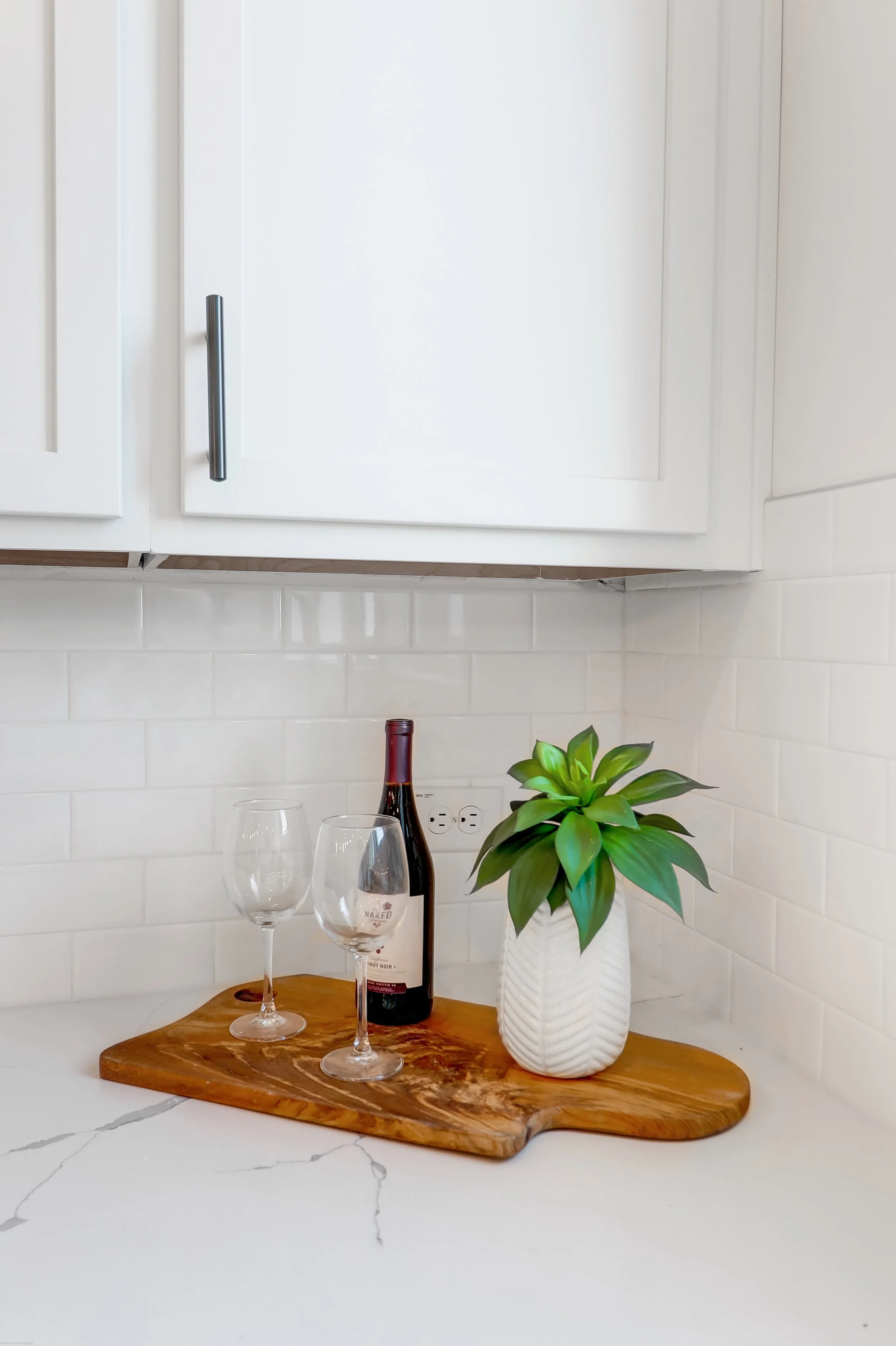 wine glasses, wine and greenery in kitchen